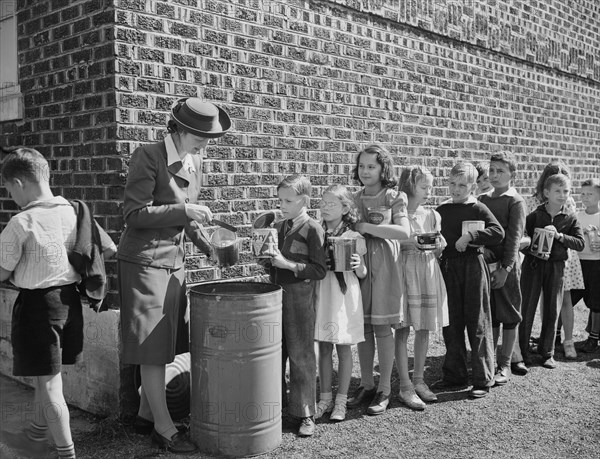 Schoolchildren Contributing to War Effort by Handing in Collected Fat and Grease, which will then be sent to Rendering Plant to extract Glycerin, Roanoke, Virginia, USA, Valentino Sarra, Office of War Information, October 1942