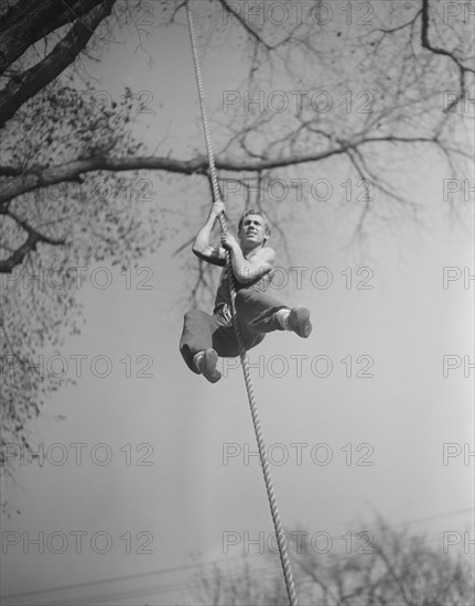 High School Victory Corps, Program Providing Training to Students Focusing on Skills Relevant to War Effort, Student Climbing Rope on Obstacle Course, Flushing, New York, USA, William Perlitch, Office of War Information, October, 1942