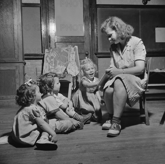 Woman Reading Story to Three Young Children at Child Care Center, New Britain, Connecticut, USA, Gordon Parks for Office of War Information, June 1943