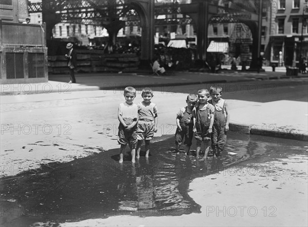 Group of Small Boys Standing in Street Puddle, New York City, New York, USA, Bain News Service, July 1913