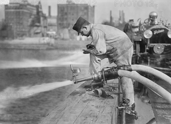 Fireman Testing Fire Engine, New York City, New York, USA, Bain News Service, September 1913