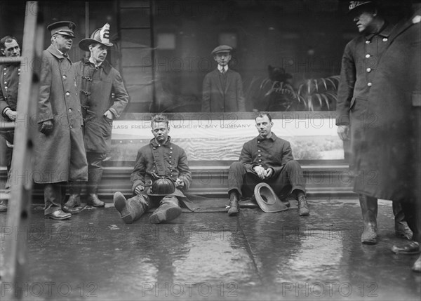 Firemen Seated on Sidewalk after Fighting Subway Tunnel Fire, West 55th Street and Broadway, New York City, New York, USA, Bain News Service, January 1915
