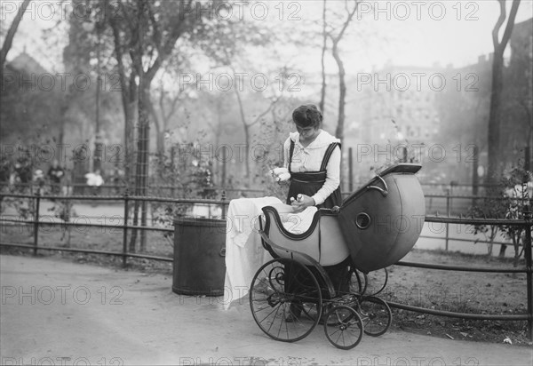 Woman with Baby Carriage Holding Milk Bottles from Depot set up by merchant Nathan Straus that Provides Pasteurized Milk to Poor Families, New York City, New York, USA, Bain News Service, 1917