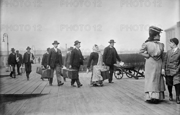 Immigrants Carrying Luggage, Ellis Island, New York City, New York, USA, Bain News Service, 1910