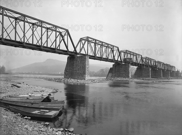 Man Fishing in boat under Railroad Bridge, Susquehanna River, Pittston, Pennsylvania, USA, Detroit Publishing Company, 1900