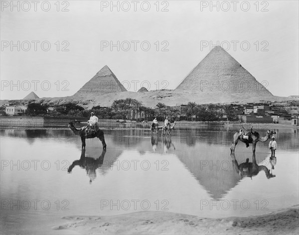 Men and Camels in Shallow Flood Water with Pyramids in Background, Egypt, 1890