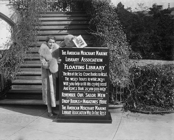 First Lady Grace Coolidge Dropping First Book into Box That Started Drive by American Merchant Marine Library Association for "Floating Library" for Sailors, Washington DC, USA, Harris & Ewing, January 1929