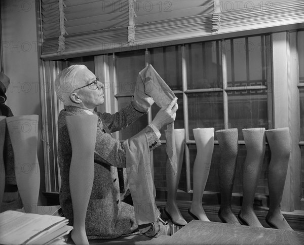 David H. Young, Agriculture Department Fabric Technician, Examining Cotton Stockings, which is trying to be Popularized over Silk and Nylon, Washington DC, USA, Harris and Ewing, July 1941