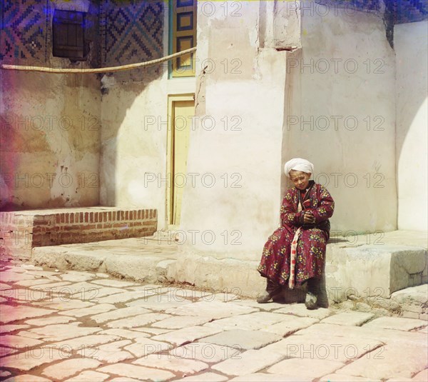 Portrait of Boy Seated in Courtyard of Mosque, Shir-Dor Mosque, Samarkand, Uzbekistan, Russian Empire, Prokudin-Gorskii Collection, 1910