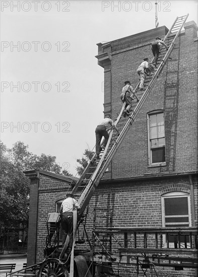 Firemen Climbing Ladder onto Building, Firemen's School, Washington DC, USA, Harris & Ewing, 1921
