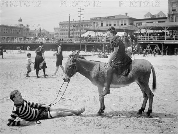 Woman Sitting on Donkey While Man Lays on Sand Holding Reins, Atlantic City, New Jersey, USA, Detroit Publishing Company, 1901