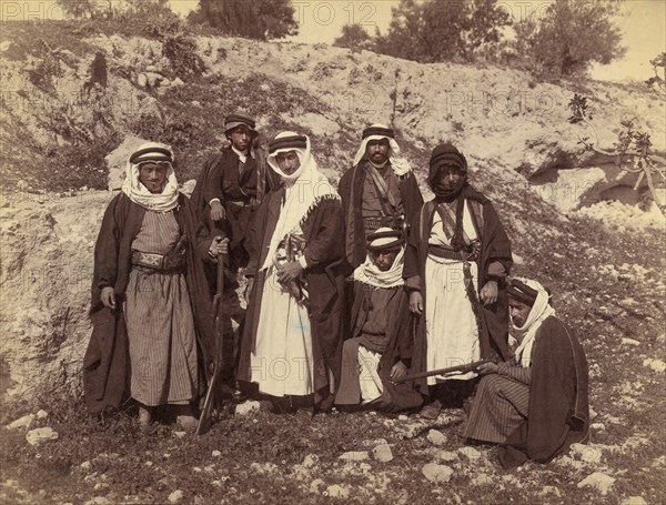 Bedouin Men of Arakat Tribe, Portrait in Rocky Landscape with Swords and Rifles, American Colony Photo Department, early 1900's