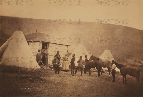 British Captain John MacDonnell Webb, 4th Dragoon Guards, standing in Doorway of Hut looking at Colonel Edward Cooper Hodge (standing in profile), Mrs. Rogers, Webb's servant with a horse, and several others;