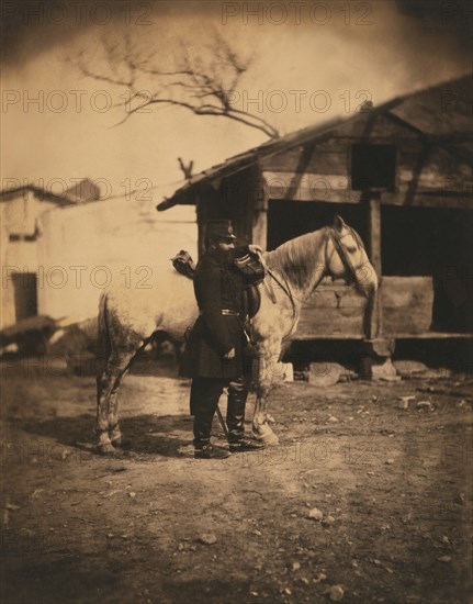 British Major Keane, full-length Portrait in Uniform, Standing with Horse, Wooden Huts in Background, Crimean War, Balaklava, Ukraine, by Roger Fenton, 1855