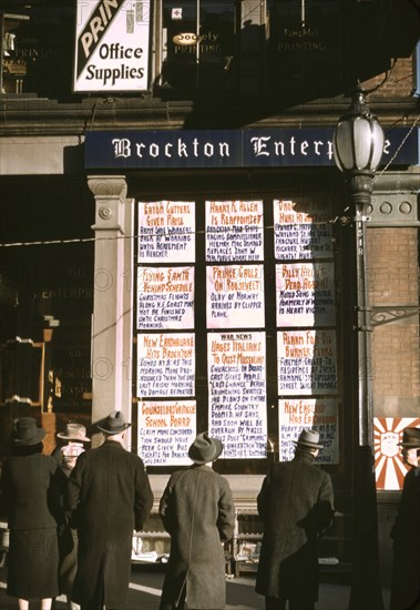 Men and Women Reading Headlines Posted in Street-Corner Window of Brockton Enterprise, Newspaper Office on Christmas Eve, Brockton, Massachusetts, USA, Jack Delano for Farm Security Administration - Office of War Information, December 1940