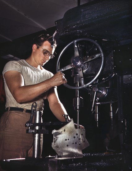 Worker in Drill-Press Section of Machine Shop running Mounting Holes in Large Dural Casting, North American Aviation, Inc., Manufacturer of B-25 Bomber and P-51 Mustang Fighter Planes, Inglewood, California, USA, Alfred T. Palmer for Office of War Information, October 1942