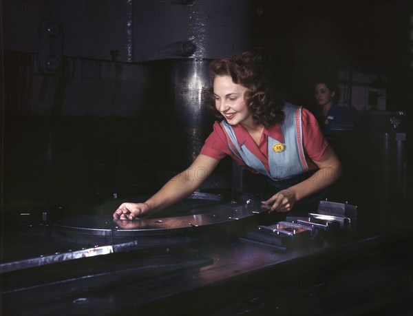 Female Worker Placing Metal Parts on Masonite Before Being Slid Under Multi-Ton Hydropress, North American Aviation, Inc., Inglewood, California, USA, Alfred T. Palmer for Office of War Information, October 1942