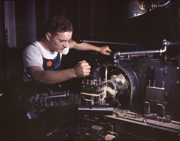 Worker in Machine Shop Finishing Aircraft Part on Huge Turret Lathe, North American Aviation, Inc., Inglewood, California, USA, Alfred T. Palmer for Office of War Information, October 1942
