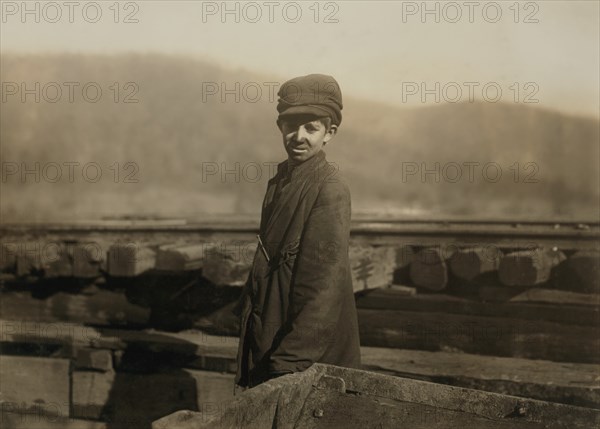 Harley Bruce, Young Coupling Boy at Tippling of Indian Mountain Mine, Proctor Coal Company, Three-Quarter Length Portrait, near Jellico, Tennessee, USA, Lewis Hine for National Child Labor Committee, December 1910