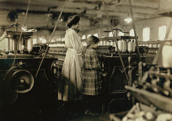 Underage Girl, possibly 8 years old, Working alongside older Girl, Newton Cotton Mills, Newton, North Carolina, USA, Lewis Hine for National Child Labor Committee, December 1908