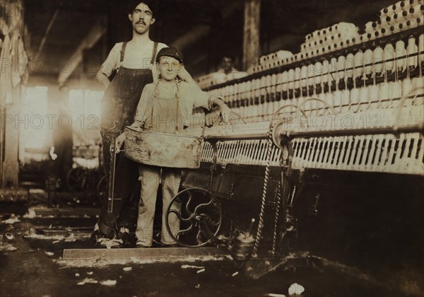 Young "Tube Boy" with Injured Finger and Overseer in Mule Room, Richmond Spinning Mill, East Lake, Chattanooga, Tennessee, USA, Lewis Hine for National Child Labor Committee, December 1910
