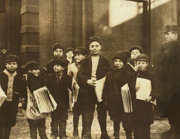 Group of Young Newsboys hanging Around Newspaper Office After School, Full-Length Portrait, Buffalo, New York, USA, Lewis Hine for National Child Labor Committee, February 1910