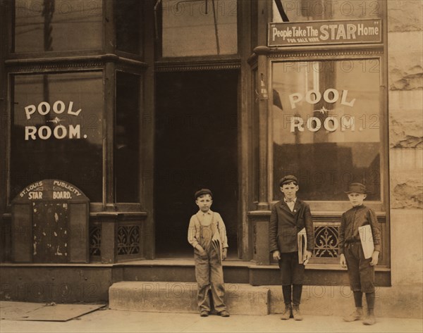 Three Young Newsboys, Portrait Standing outside Pool Hall after Receiving Afternoon Newspapers, Boys were Smoking and Playing Pool while Waiting for Papers, Youngest Boy is 9 years old and Sells until 9:00 p.m., Chouteau and Manchester Streets, St. Louis, Missouri, USA, Lewis Hine for National Child Labor Committee, May 1910