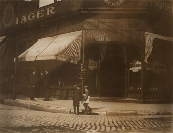 Two Young Boys Selling Newspapers on Street Corner outside Saloon, St. Louis, Missouri, USA, Lewis Hine for National Child Labor Committee, May 1910