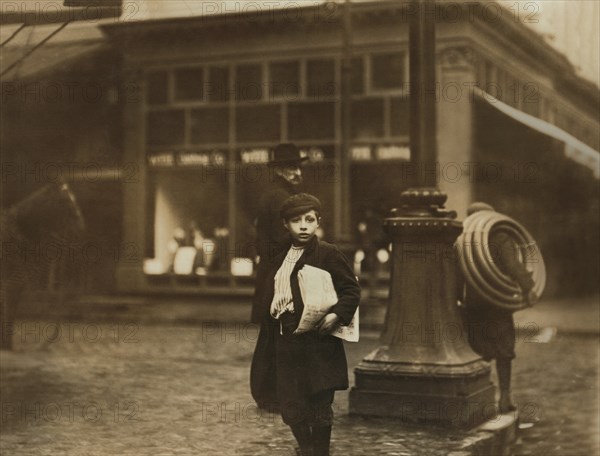 Young Newsboy on Street Corner at Night, Olive & 6th Street, St. Louis, Missouri, USA, Lewis Hine for National Child Labor Committee, May 1910
