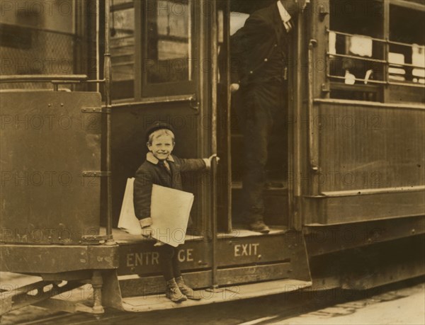 Francis Lane, 5-year-old Newsboy, Portrait Riding on Street Car, Grand Avenue, St. Louis, Missouri, USA, Lewis Hine for National Child Labor Committee, May 1910