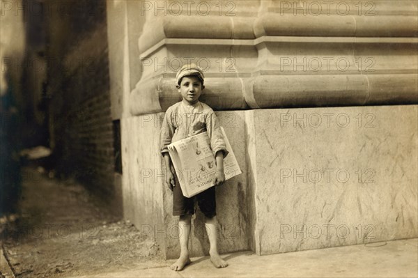 Young Newsboy, Full-Length Portrait Standing in Bare Feet, Norfolk, Virginia, USA, Lewis Hine for National Child Labor Committee, June 1911