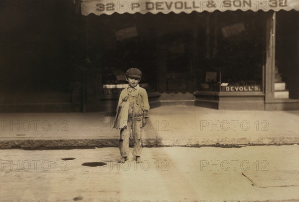 Fernace Silvia, 7 years, Newsie, Portrait Standing on Street, New Bedford, Massachusetts, USA, Lewis Hine for National Child Labor Committee, August 22, 1911