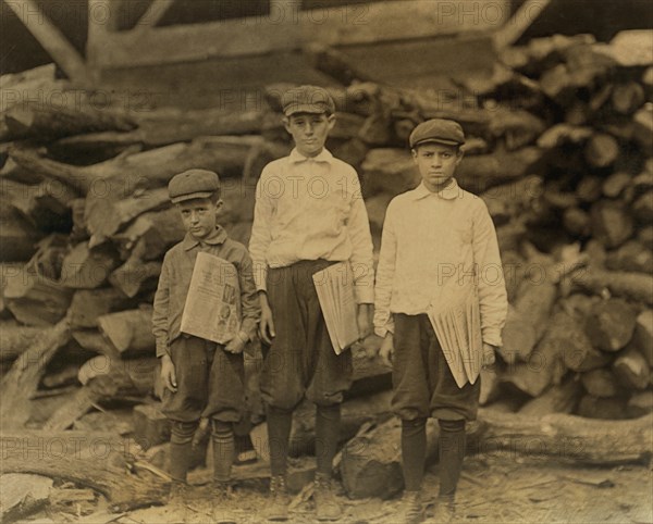 William Davison, 14 years old, George Davison, 12 years old, & Peter, 7 years old, Three Brothers Selling Newspapers, Usually starting at 4:00am and ending at 8:00pm, Full-Length Portrait, Tampa, Florida, USA, Lewis Hine for National Child Labor Committee, March 1913