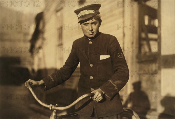 Western Union Messenger, 14 years old, Portrait with Bicycle, Houston, Texas, USA, Lewis Hine for National Child Labor Committee, October 1913