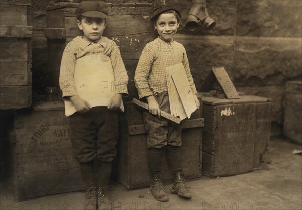 Two Young Newsboys, 7 and 9 years old, Full-Length Portrait Selling Newspapers, New Orleans, Louisiana, USA, Lewis Hine for National Child Labor Committee, November 1913