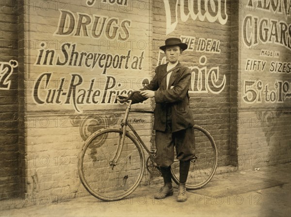 Howard Williams, 13 years old, Delivery Boy for Drug Company, works from 9:30 a.m. to 10:30 p.m., Full-Length Portrait with Bicycle, Shreveport, Louisiana, USA, Lewis Hine for National Child Labor Committee, November 1913