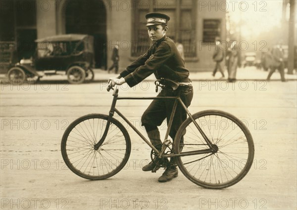 Western Union Telegraph Messenger Boy, Full-Length Portrait on Bicycle, Birmingham, Alabama, USA, Lewis Hine for National Child Labor Committee, October 1914