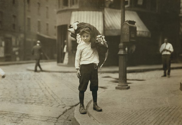 Vitto Romano, 12 years old, Carrying Load of Garments, Boston, Massachusetts, USA, Lewis Hine for National Child Labor Committee, August 1912