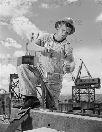 Carpenter Drilling Hole at Tennessee Valley Authority's new Douglas Dam, French Broad River, Sevier County, Tennessee, USA, Alfred T. Palmer for Office of War Information, June 1942