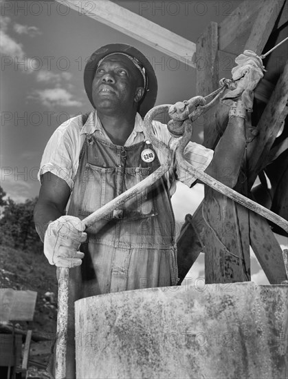 Bucket Man at Tennessee Valley Authority's new Douglas Dam, French Broad River, Sevier County, Tennessee, USA, Alfred T. Palmer for Office of War Information, June 1942