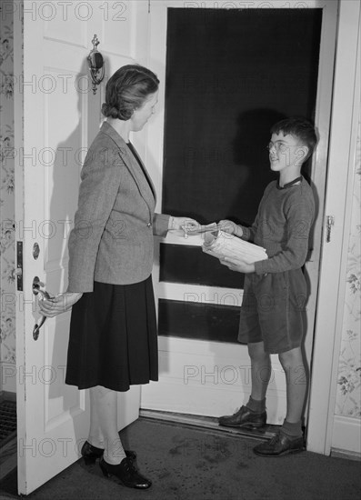 Captain Charles Wentworth, Junior Commando, Handing Mrs. John Farr a Leaflet Announcing Collection of Scrap Metal and Rubber during Scrap Salvage Campaign, Roanoke, Virginia, USA, Howard Liberman for Office of War Information, October 1942