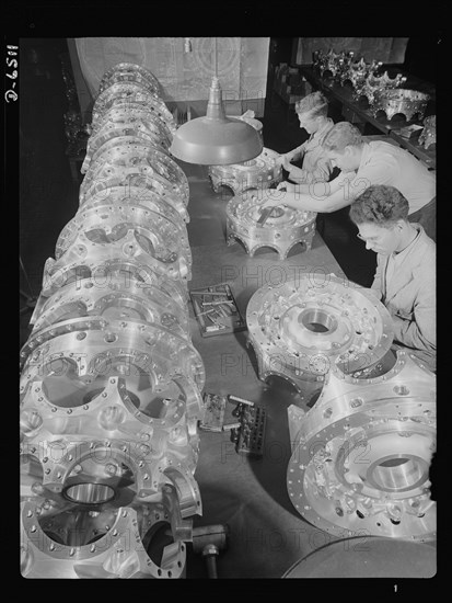 Three Workers Carefully Inspecting Power Section Crank Cases for Airplane Engines at Manufacturing Plant, Pratt & Whitney, East Hartford, Connecticut, USA, Andreas Feininger for Office of War Information, June 1942