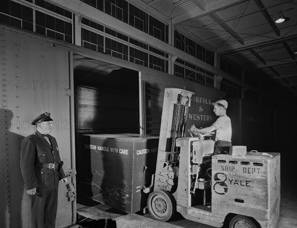 Airplane Motor is Loaded on Freight Car from Platform of Manufacturing Plant, Pratt & Whitney, East Hartford, Connecticut, USA, Andreas Feininger for Office of War Information, June 1942