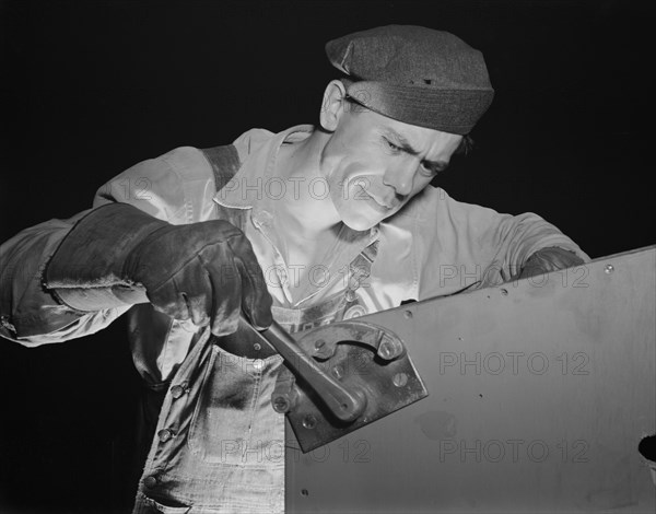 Worker working on Fifty-Foot Steel Ramp Boat, Higgins Industries, New Orleans, Louisiana, USA, Howard R. Hollem for Office of War Information, July 1942