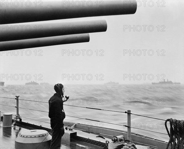 U.S. Navy Sailor on Naval Vessel Keeping Alert Watch over Merchant Ships Delivering Vital Supplies to U.S. and Allied Forces in Europe, Atlantic Ocean, Office of War Information, 1940's