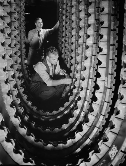 Two Workers Inspecting Tracks for Army's Half-Track Scout Cars, BF Goodrich, Akron, Ohio, USA, Alfred T. Palmer for Office of War Information, December 1941