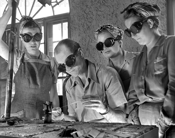 Instructor Training Three Women to Weld Aircraft at Vocational School as part of Program to Provide more Workers for War Production for Florida's Pooling Program, De Land, Florida, USA, Howard R. Hollem for Office of War Information, April 1942