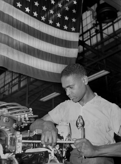 Zed W. Robinson, Factory Worker, Tightening Bolts of Cylinder Barrel during Final Build-up of Airplane Engine at Buick Plant Converted for War Product Production, Melrose Park, Illinois, USA, Ann Rosener, Office of War Information, July 1942