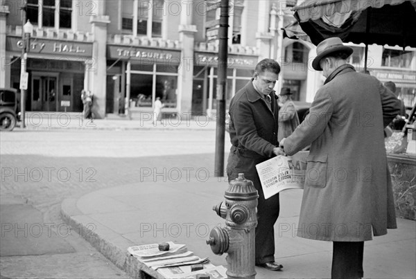 Man Selling Newspapers on Street Corner, Manchester, New Hampshire, USA, Carl Mydans for U.S. Resettlement Administration, August 1936