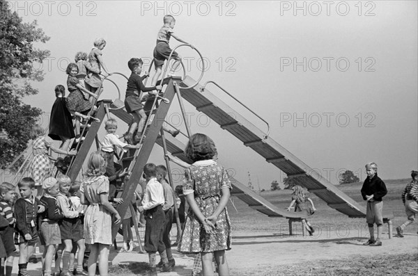 Children Playing at School Playground, Greenhills, Ohio, USA, a Greenbelt Community Constructed by U.S. Department of Agriculture as Part of President Franklin Roosevelt's New Deal, John Vachon for U.S. Resettlement Administration, October 1938